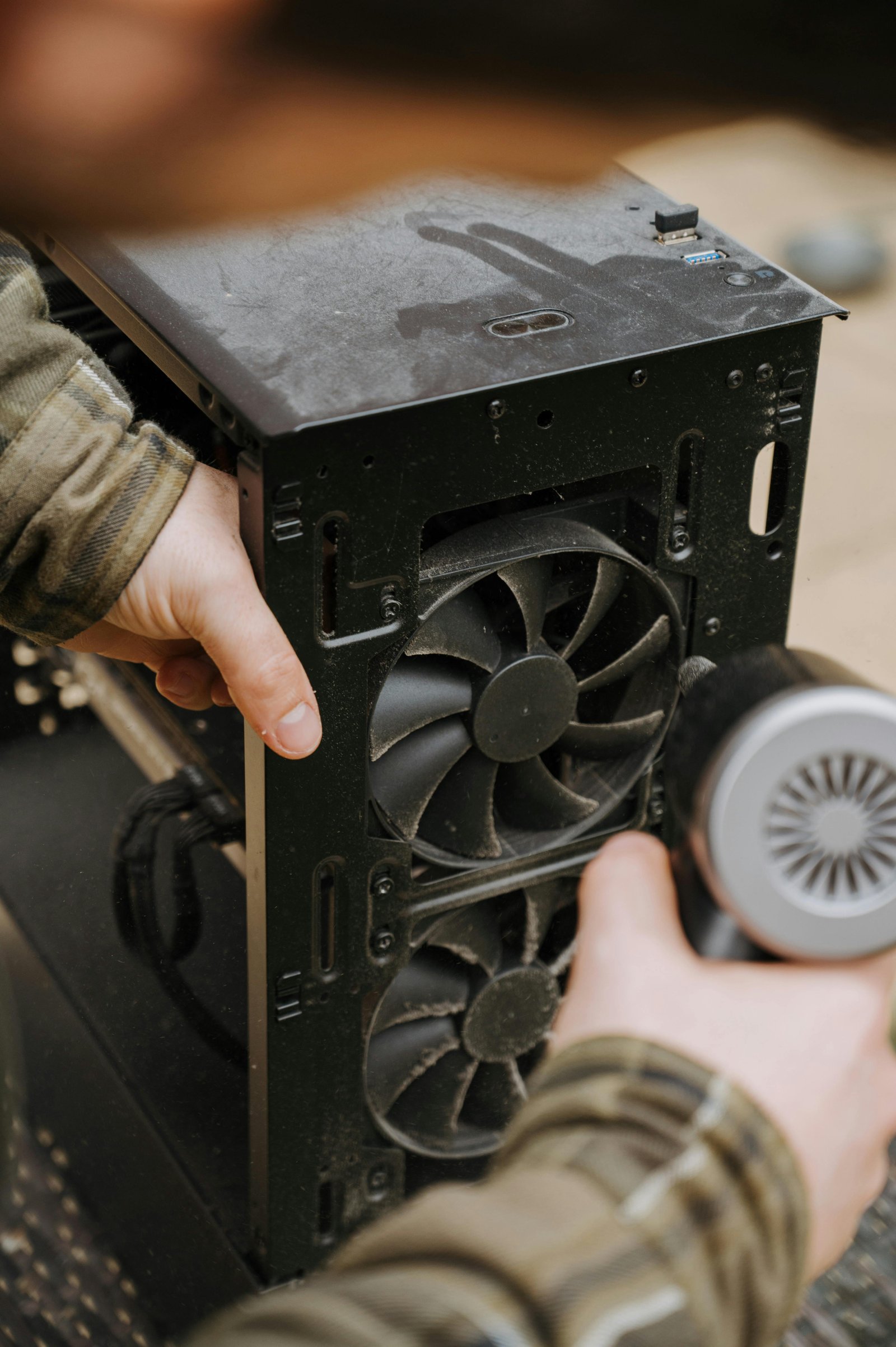 Technician cleaning internal components of a desktop PC